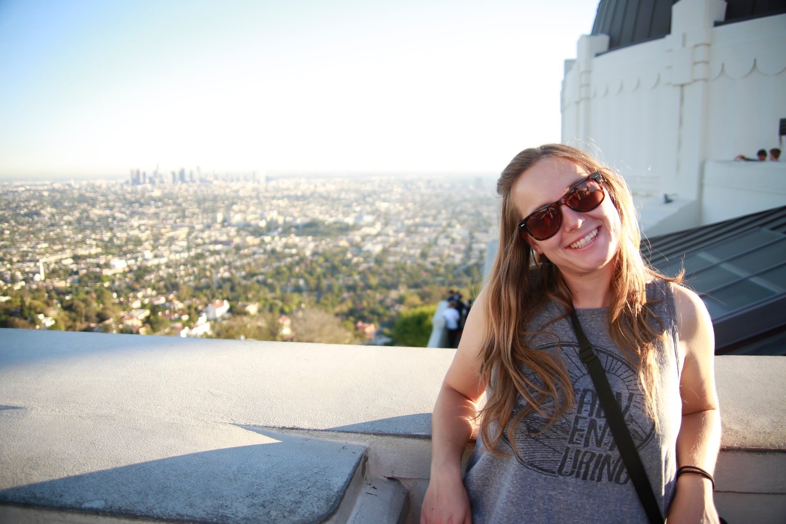 Kara smiling at the Griffith Observatory, with Los Angeles spread out behind her